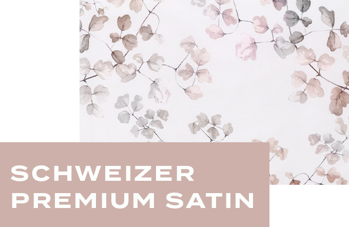 Nahaufnahme des glänzenden Schweizer Premium Satin-Stoffs in sanften Beige-, Rosé- und Grautönen