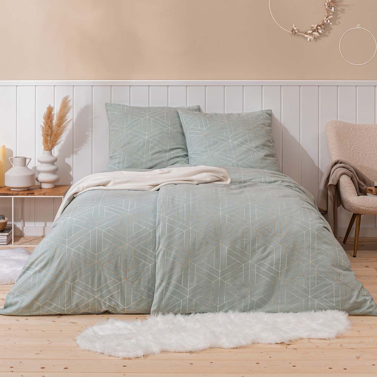 Bettwäsche Tirolo mit feinem geometrischem Linienmuster aus überlagernden geometrischen goldenen Linien auf hellen blaugrauen Grund auf Bett im Schlafzimmer