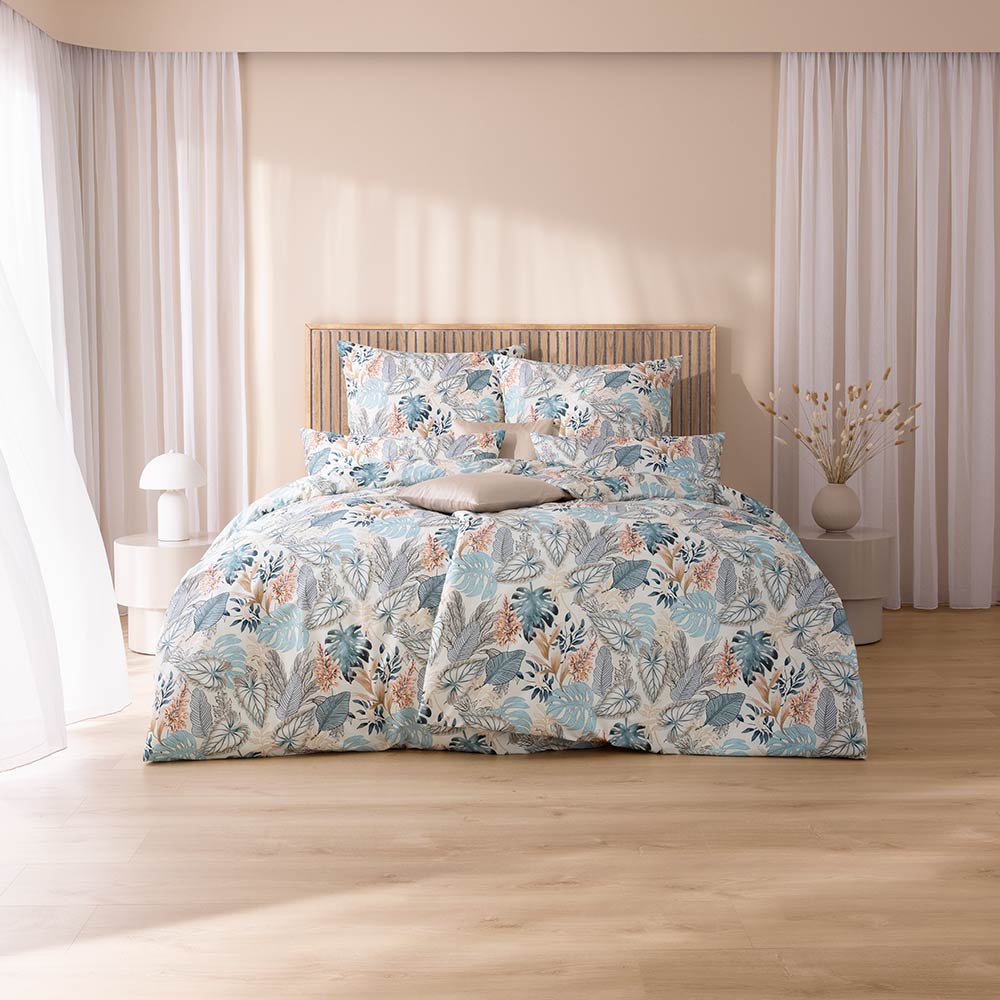 Bettwäsche Liane mit Blättermuster in Blau und Beige auf weißem Grund auf Bett im Schlafzimmer