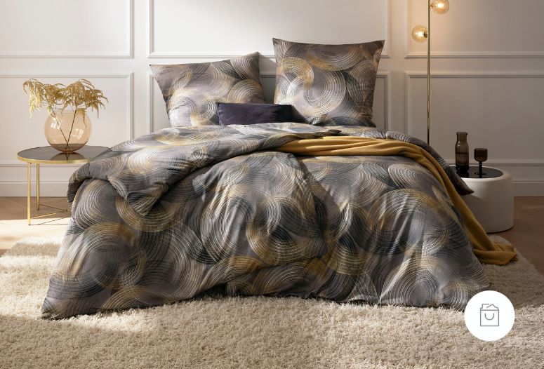 Bettwäsche Toni mit Kreismuster in Grau und Gold auf Bett im Schlafzimmer