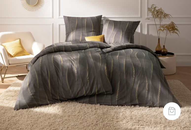 Bettwäsche Caja mit Wellenmuster in Grau und Gold auf Bett im Schlafzimmer
